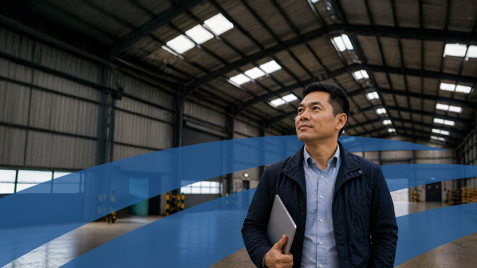 man looking relax stood in warehouse considering   EPC Compliance & Energy Upgrades