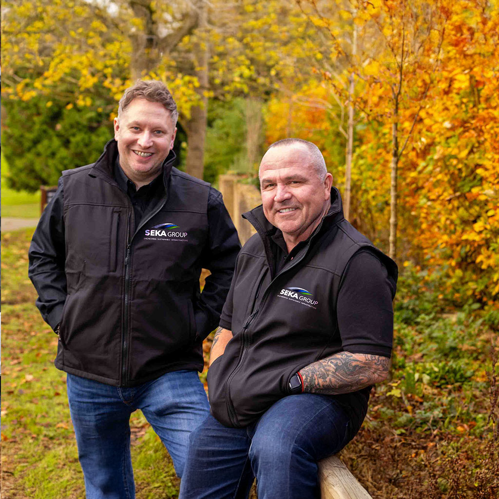 
rafal karys and mark seaton with autumn trees behind them