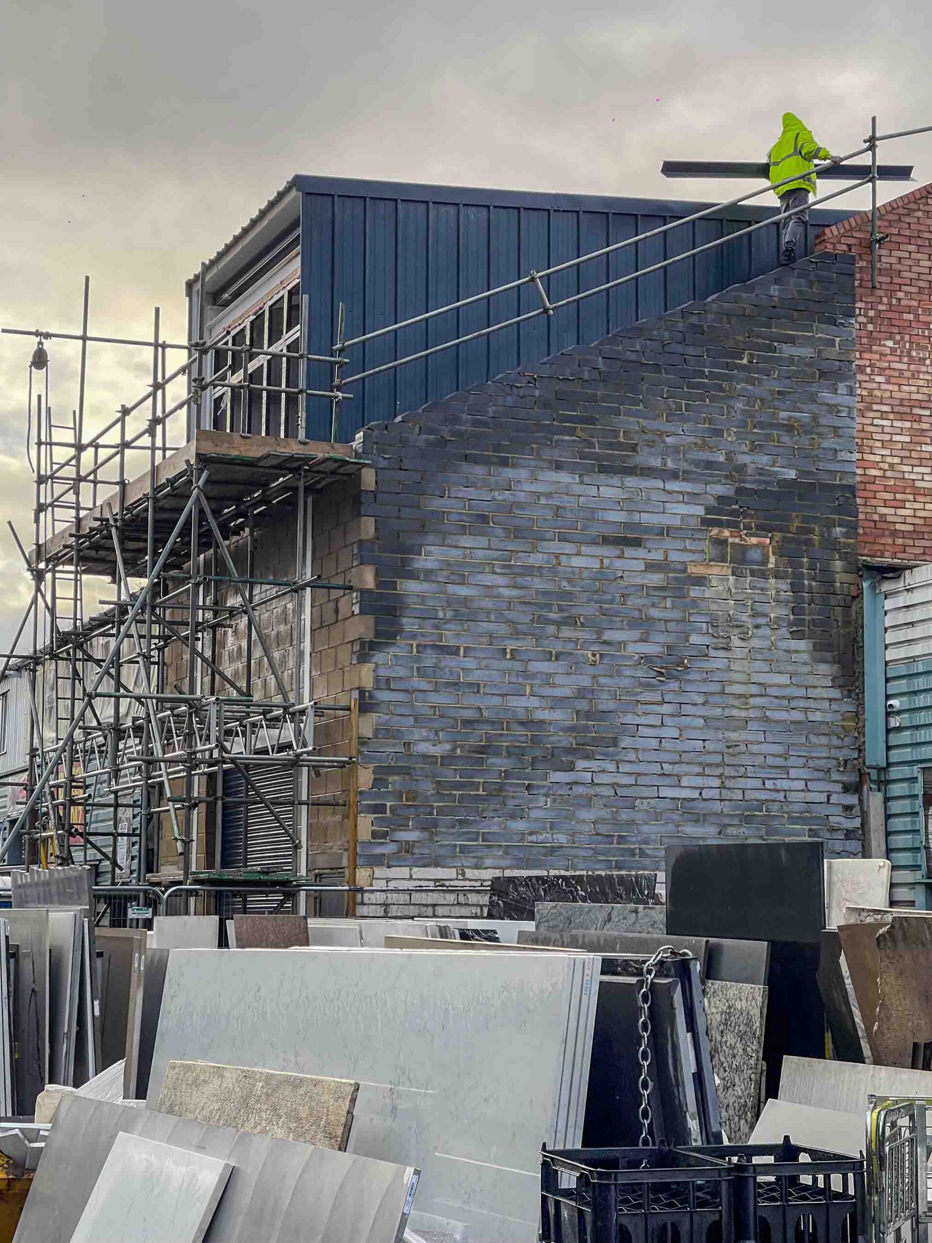 Side view of construction site with roof being built