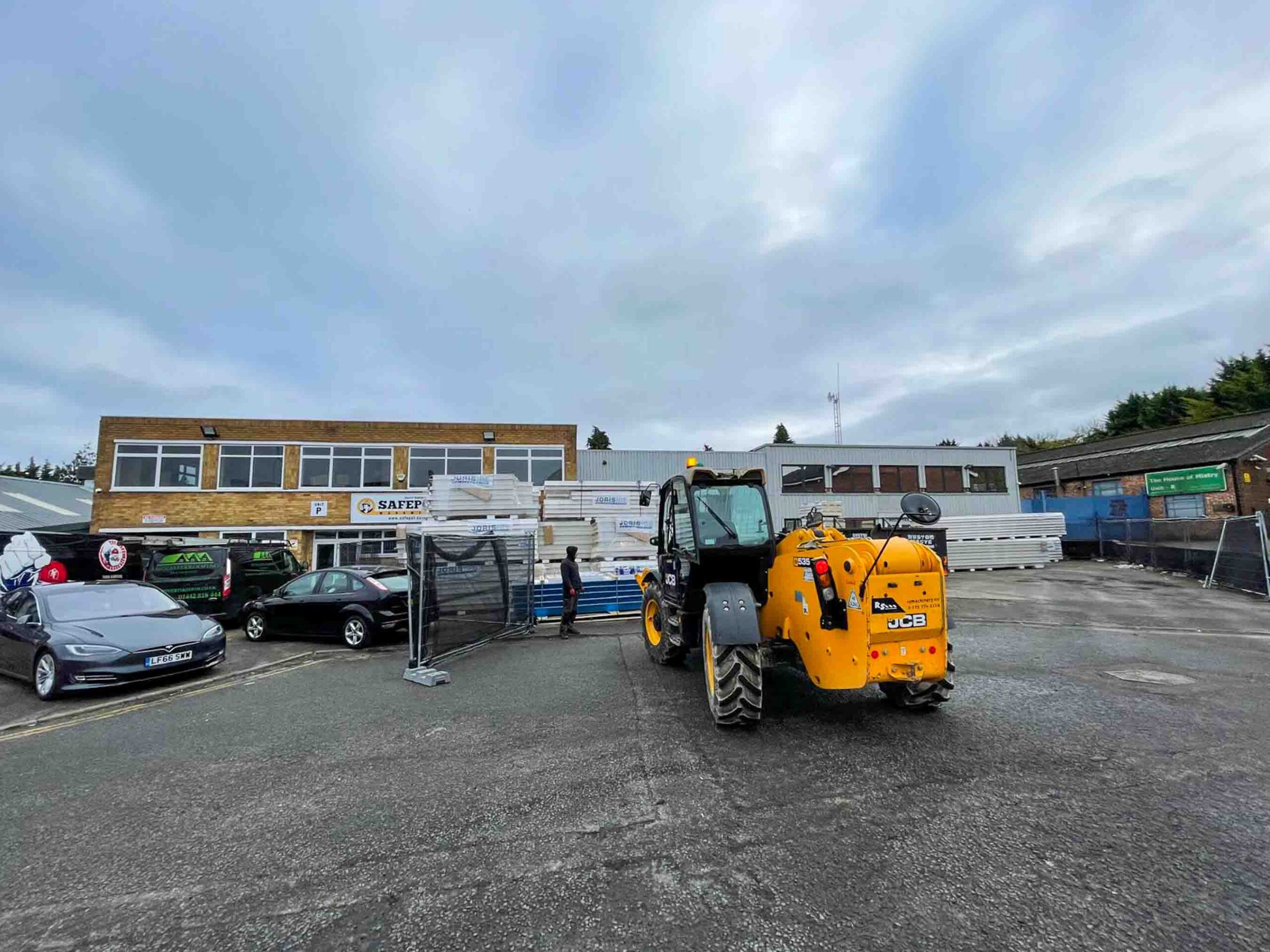 JCB fork lift moving roofing materials