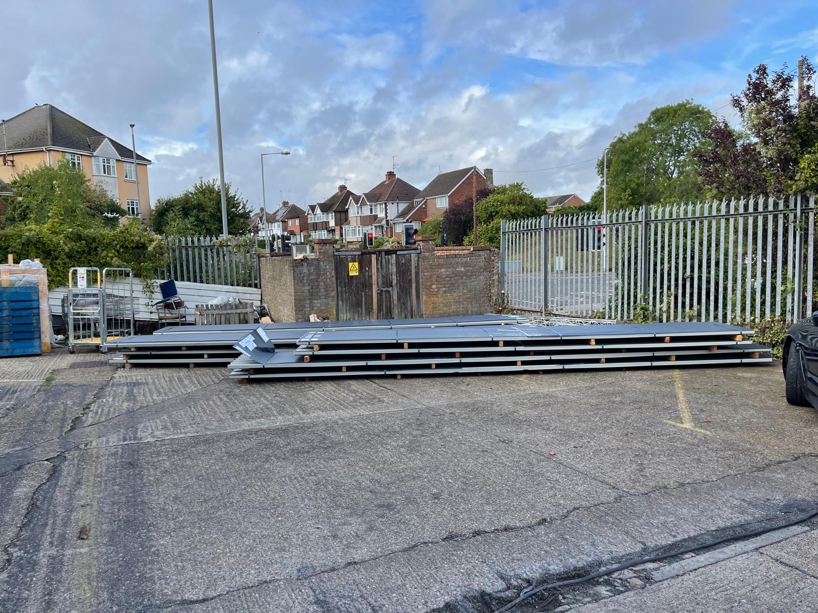 Roofing panels laid on the floor ready to be attached to building