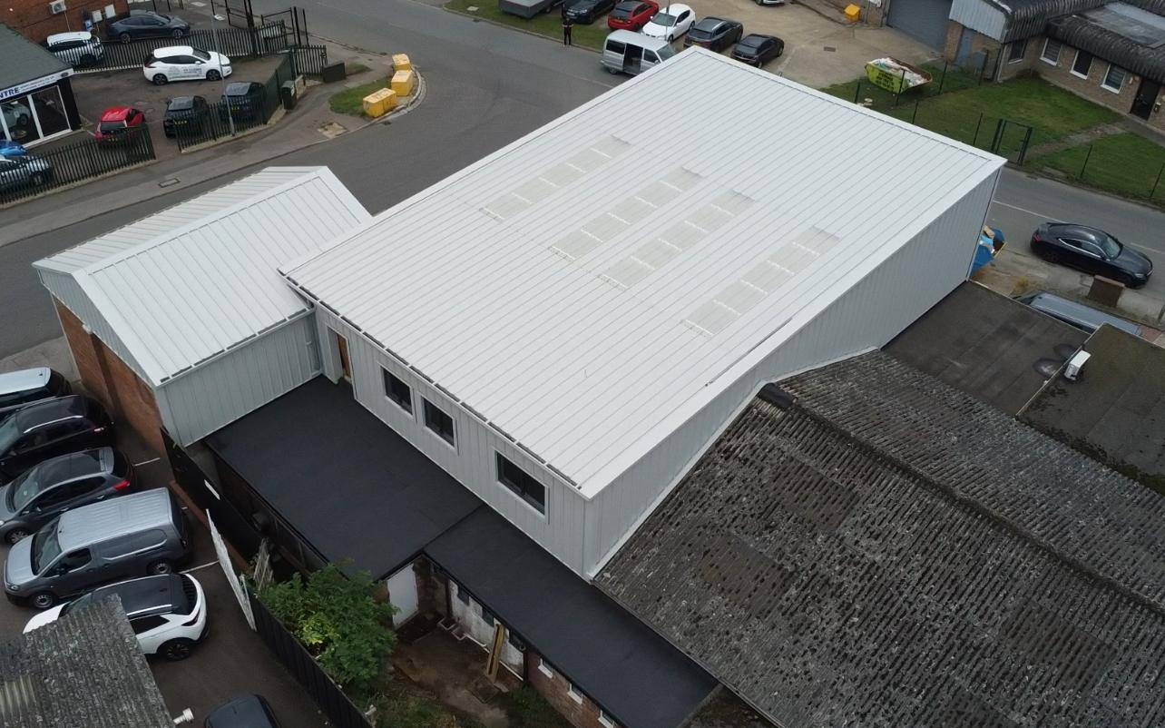 aerial view of large grey warehouse with out house
